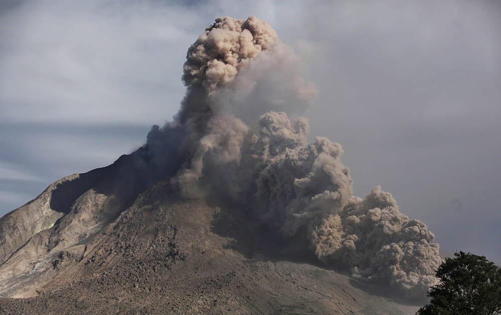 Mount Sinabung spews volcanic materials as seen from Tiga Serangkai, North Sumatra, Indonesia.