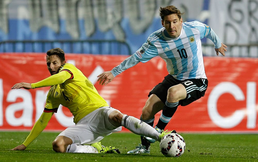 Argentina's Lionel Messi, right, is fouled by Colombia's Santiago Arias during a Copa America quarterfinal soccer match at the Sausalito Stadium in Vina del Mar, Chile.