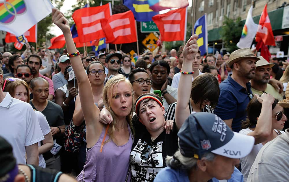 Emily Burke and Lindsay Meeks react with hundreds of others gathered during a rally in Greenwich Village to celebrate the Supreme Court's ruling on gay marriage, in New York. 