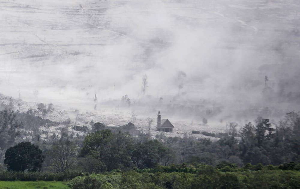 A village affected by the eruption of Mount Sinabung is covered in hot volcanic ash as seen from Tiga Serangkai, North Sumatra, Indonesia.