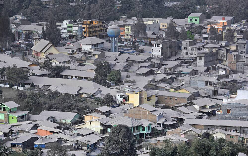 Volcanic ash from the eruption of Mount Sinabung blankets the town of Brastagi as seen from Gundaling Hill, North Sumatra, Indonesia.