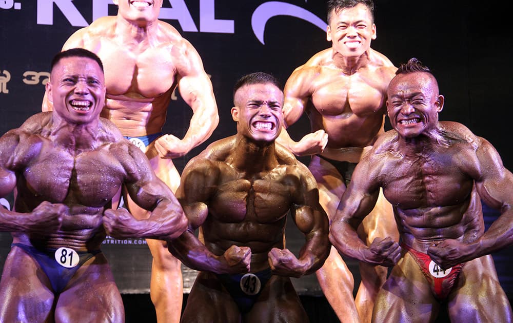 Bodybuilders compete during a bodybuilding contest organized by the Myanmar Bodybuilder Federation at the Myanmar Convention Center (MCC) in Yangon, Myanmar.