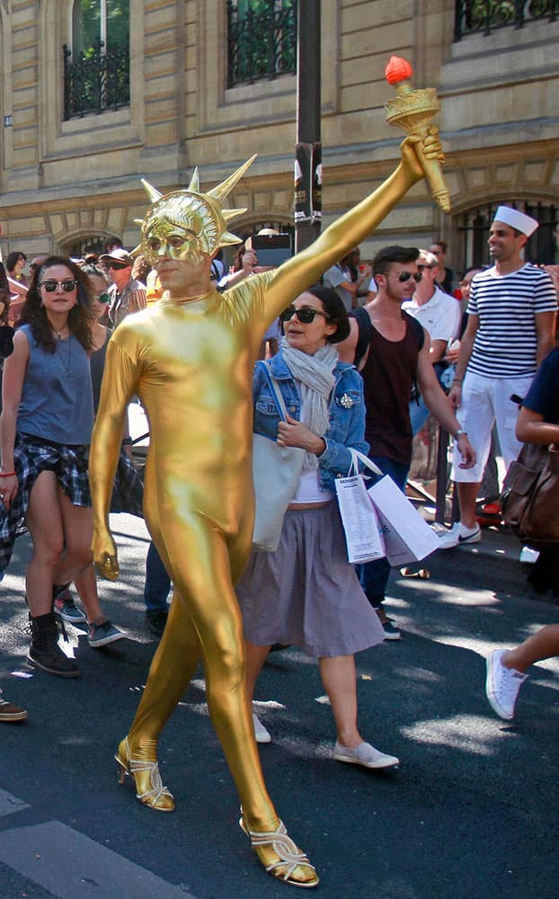 A participant in the annual Gay Pride march parades in a street of Paris.