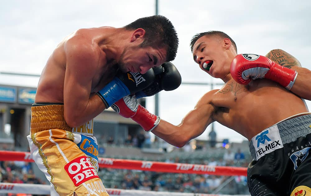 Oscar Valdez, right, of Mexico connects with Ruben Tamayo, of Mexico during a featherweight boxing match, in Carson, Calif.