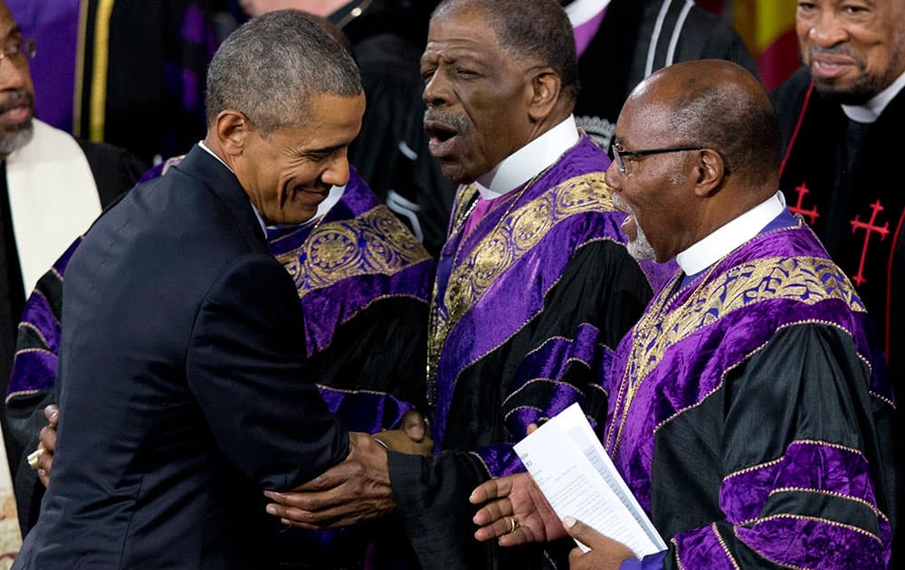 President Barack Obama is greeted by bishops of the Emanuel AME Church as he leaves stage after speaking during services honoring the life of Rev. Clementa Pinckney, in Charleston, S.C., at the College of Charleston TD Arena.