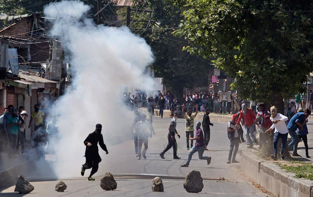 protesters throw stones and bricks at policemen during a protest in Srinagar.