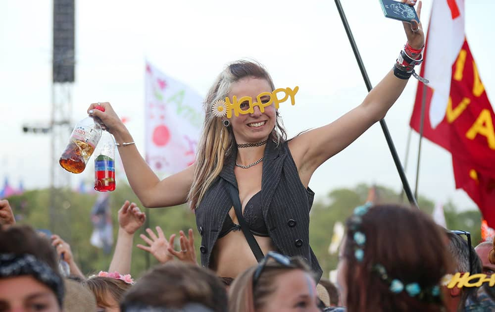 A music lover watches Pharrell Williams during the Glastonbury Music Festival at Worthy Farm, Glastonbury, England. 