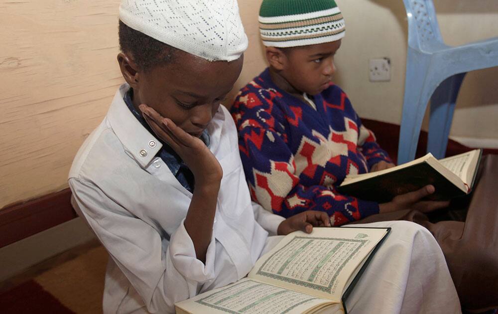 Kenyan Muslim children read verses of Quran, on the 11th day of the Muslim holy month of Ramadan at a Madrassa, in Nairobi, Kenya.