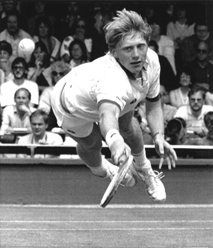 In this July 1, 1985 file photo, Boris Becker, of West Germany, dives to make a return to his opponent Joakim Nystrom, of Sweden, in the men's singles third round play at the All England Lawn Tennis Championships in Wimbledon, London.