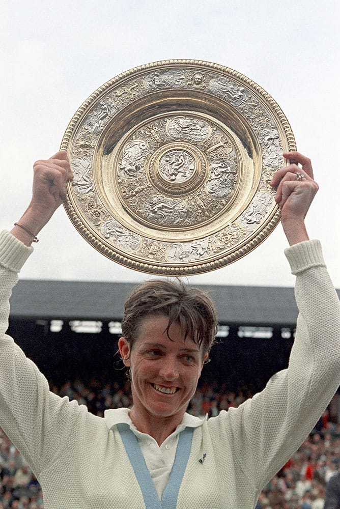 In this 1970 file photo Margaret Court of Australia holds her trophy aloft after winning the women's singles, at the All England Lawn Tennis Championships in Wimbledon, London. 