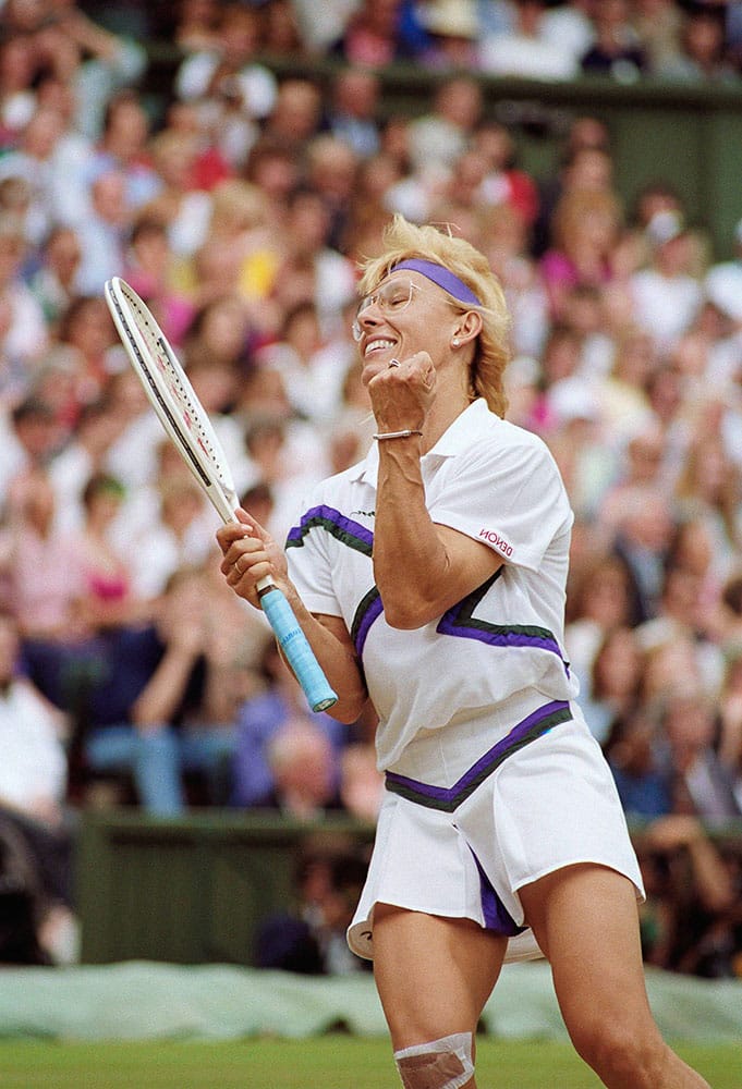 In this July 7, 1990 file photo, Martina Navratilova celebrates during the Ladies Singles Championship match with fellow American, Zina Carrison at the All England Lawn Tennis Championships in Wimbledon, London. 