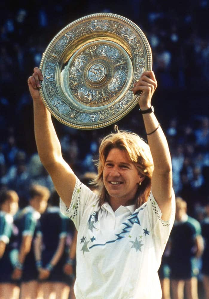 In this July 2, 1988 file photo, Germany's Steffi Graf holds up the Championship Plate, after beating defending champion Martina Navratilova at the All England Lawn Tennis Championships in Wimbledon, London.