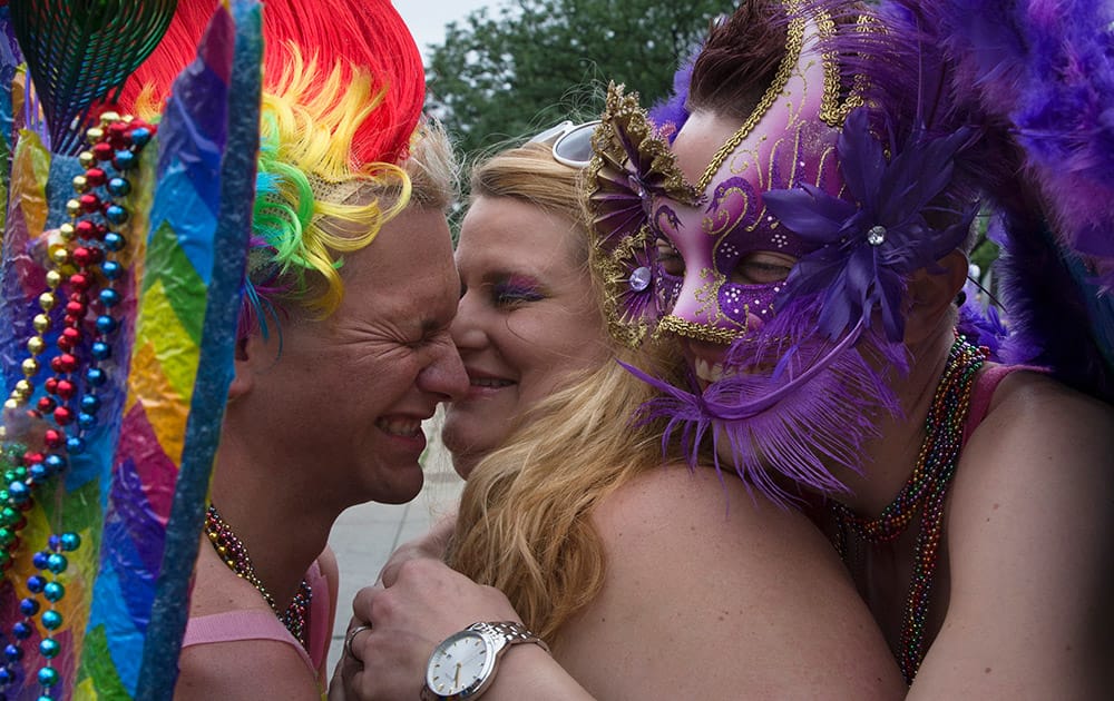 Revelers hug before stepping off during the Cincinnati Pride parade.