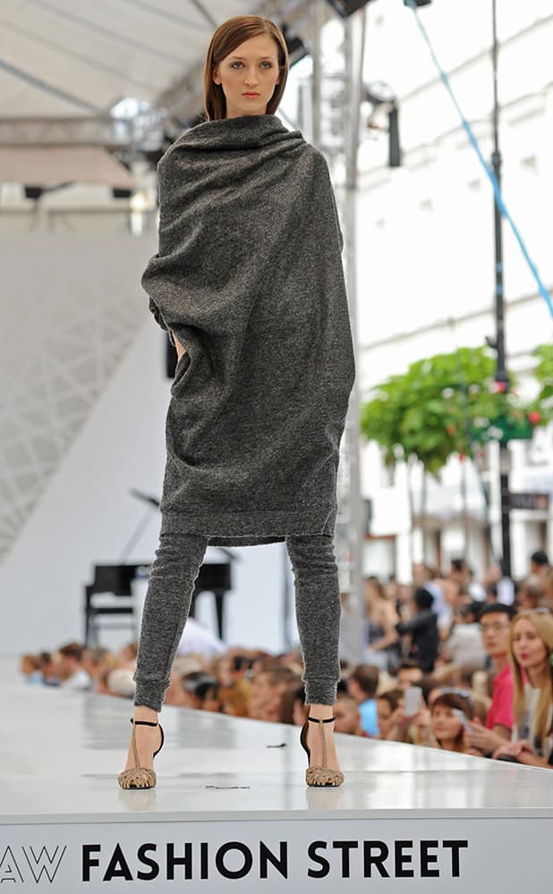 A model presents a creation by Polish designer Aga Guz during the Warsaw Street Fashion show on a downtown street in Warsaw, Poland.