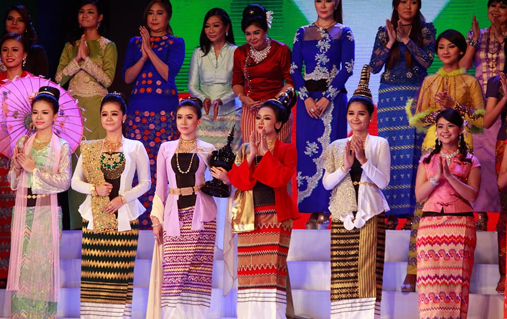 Myanmar models present traditional dresses creation of local designers during a fashion show to mark Myanmar Women Day at the National Theater.