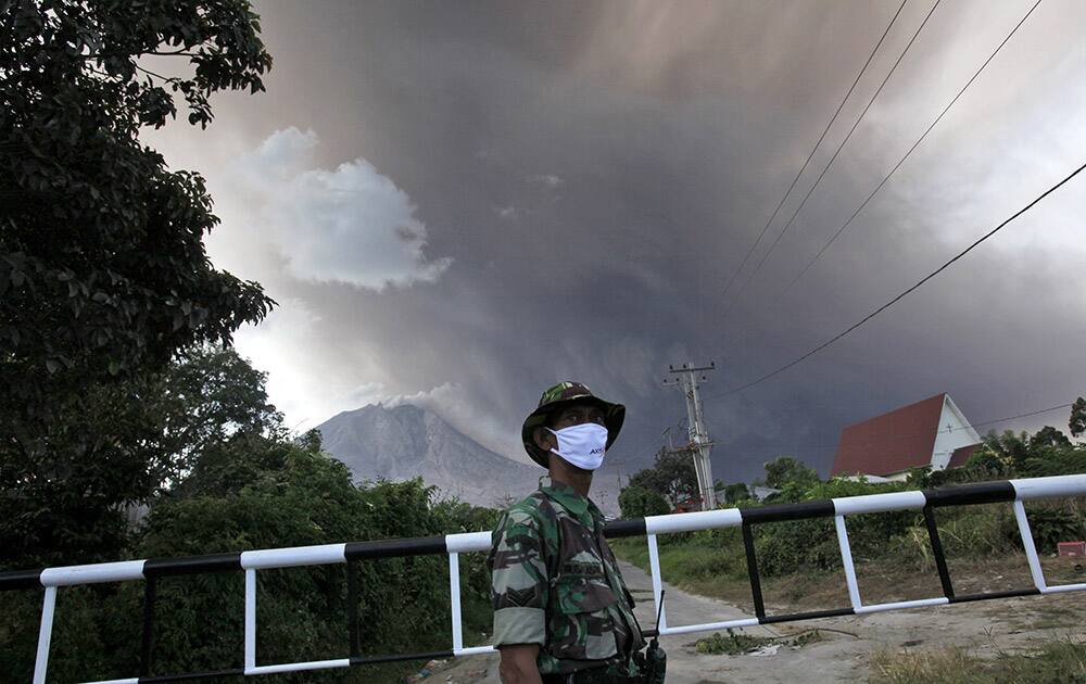 AN INDONESIAN SOLDIER MANS A CHECK POINT ON A ROAD LEADING TO THE AREA MARKED AS DANGER ZONE ON THE SLOPES OF MOUNT SINABUNG IN SIBINTUN, NORTH SUMATRA, INDONESIA.