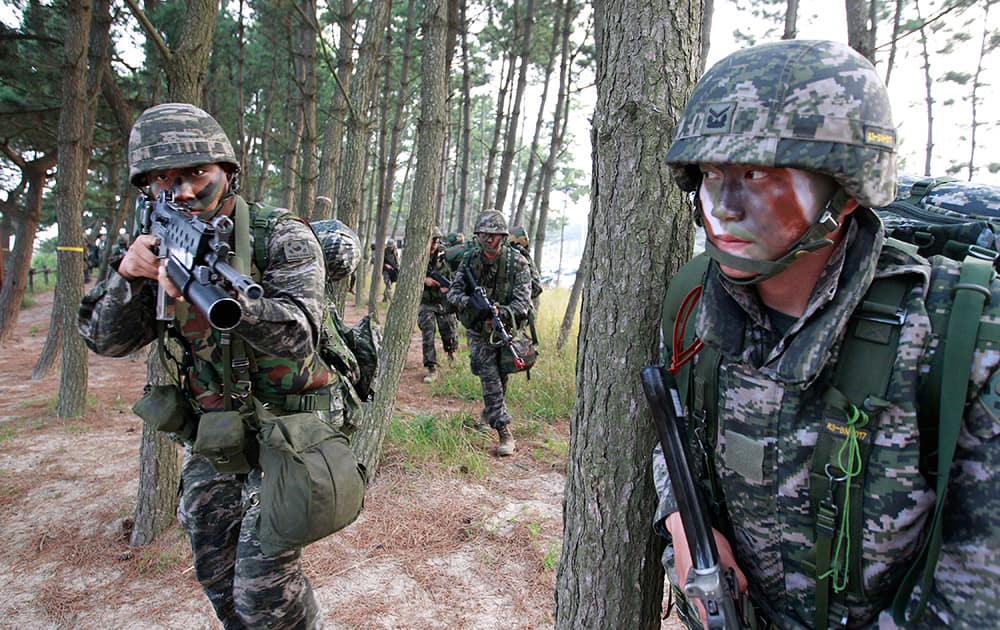 South Korean Marines move after they landed on the beach during a landing exercise in Taean, western South Korea.