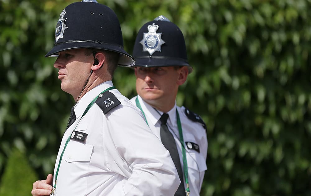 Police officers patrol the grounds before the start of the All England Lawn Tennis Championships in Wimbledon, London.