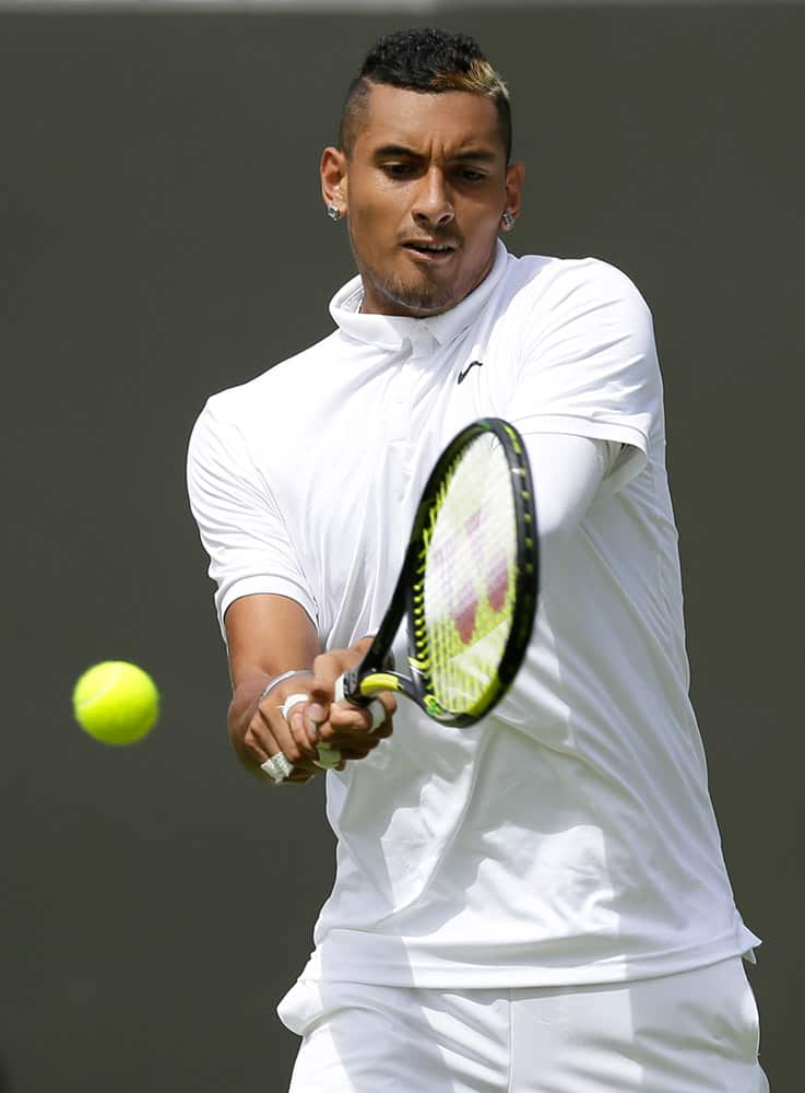 Nick Kyrgios of Australia returns a ball to Diego Schwartzman of Argentina during the men's singles first round match against at the All England Lawn Tennis Championships in Wimbledon, London.