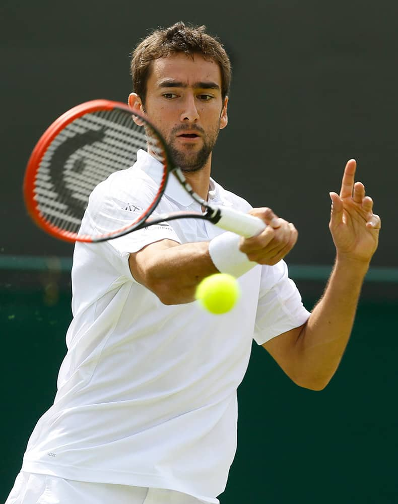 Marin Cilic of Croatia returns the ball to Hiroki Moriya of Japan during the men's singles first round match at the All England Lawn Tennis Championships in Wimbledon, London.