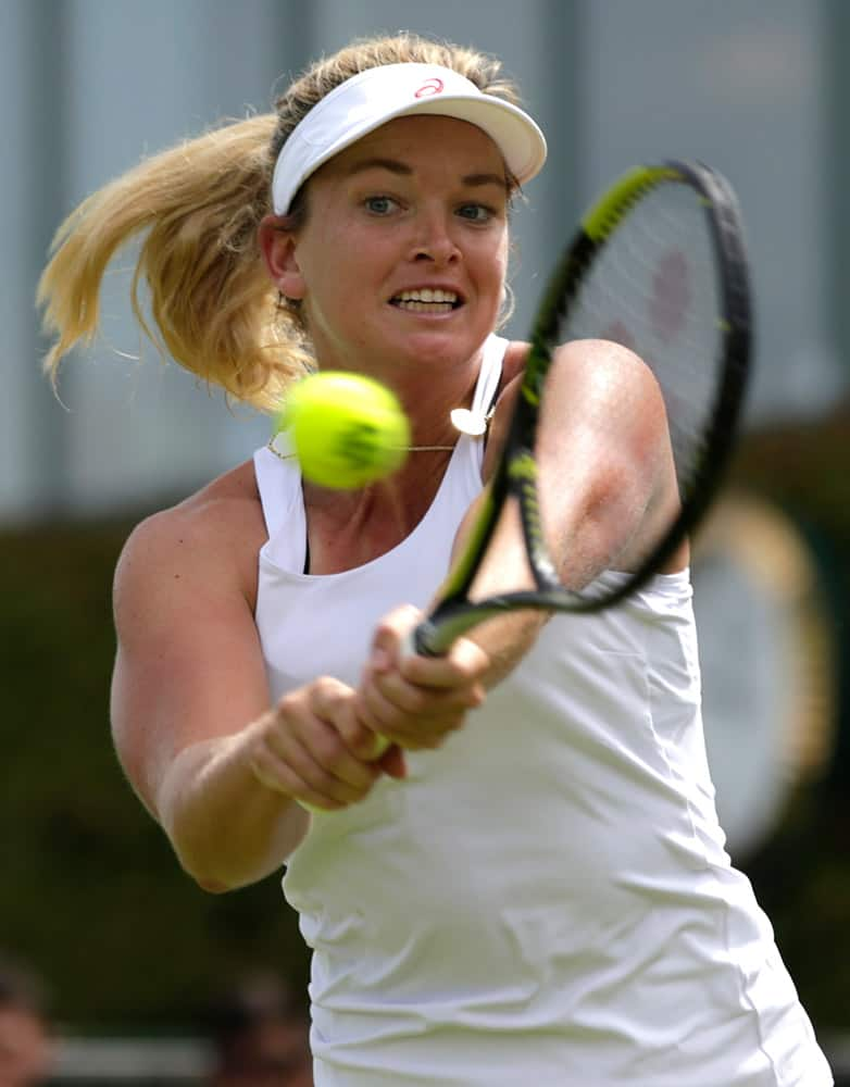 Coco Vandeweghe of the United States returns a ball to Anna Karolina Schmiedlova of Slovakia during the women's singles first round match at the All England Lawn Tennis Championships in Wimbledon, London