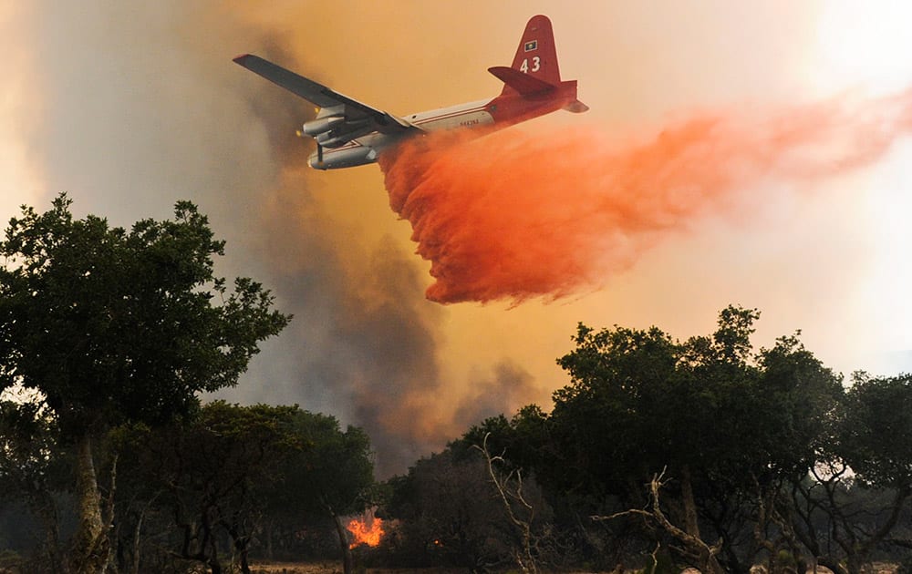 A plane drops a load of retardant on a wildfire north of Lompoc, Calif.