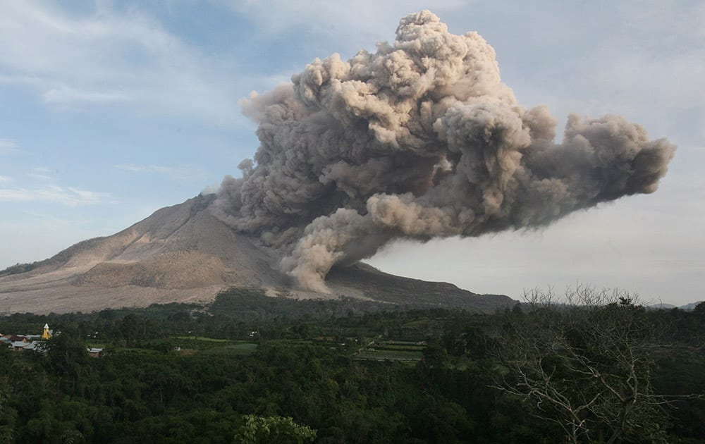 Mount Sinabung spews volcanic ash into the air as seen from Jeraya, North Sumatra, Indonesia.