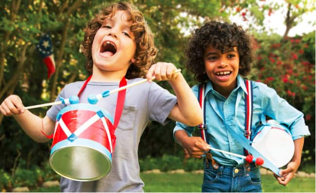 This photo provided by courtesy of FamilyFun magazine shows young boys playing with their mini-marching drums made from recycled coffee cans in a backyard.