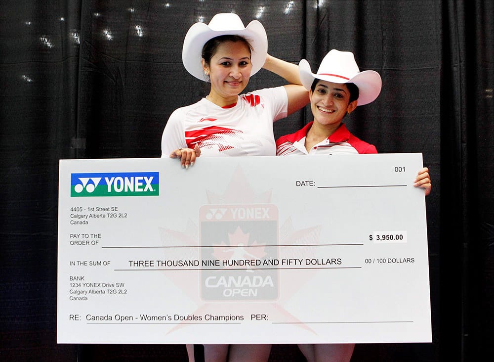 Indias Jwala Gutta and Ashwini Ponnappa pose for photographs after winning Canada Open womens doubles title in Calgary, Canada.