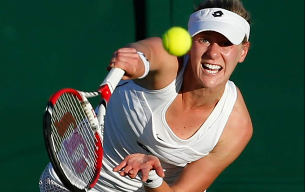 Alison Riske of the United States serves to Lucie Safarova of the Czech Republic during the women's singles first round match at the All England Lawn Tennis Championships in Wimbledon, London.