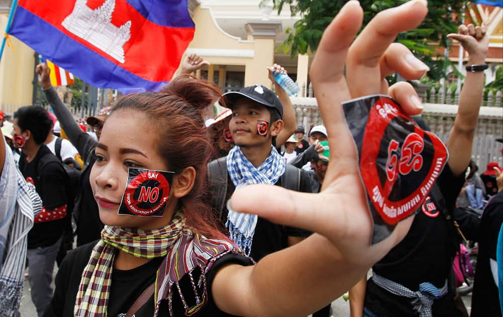 Cambodian workers have stickers on their faces reading 