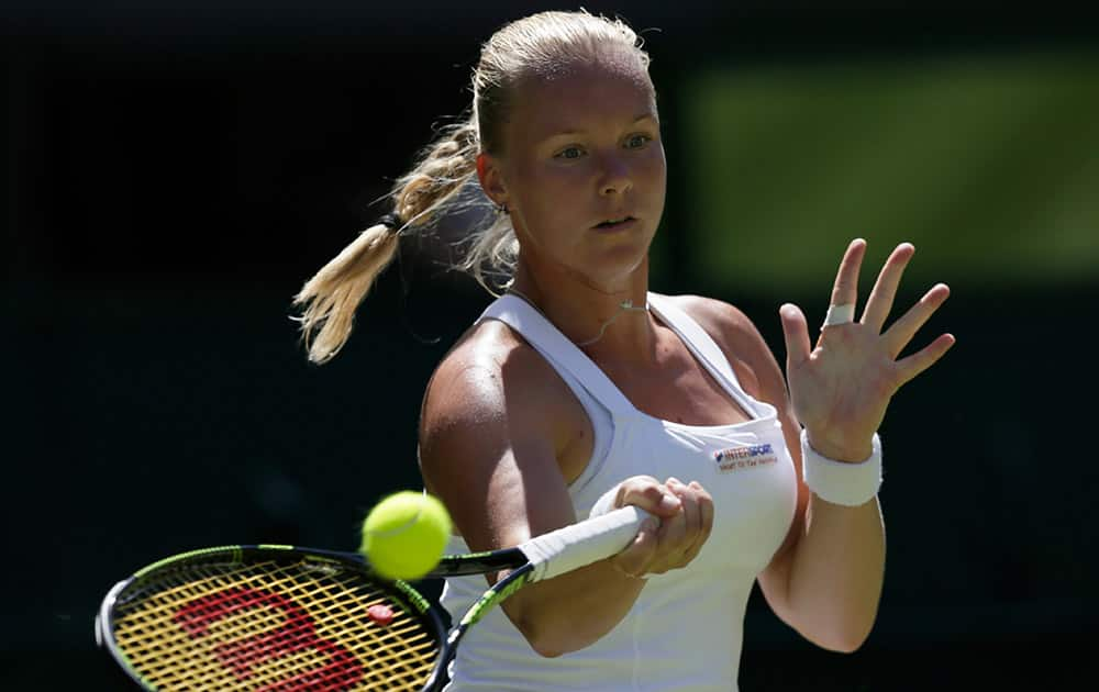 Kiki Bertens of the Netherlands plays a return to Petra Kvitova of the Czech Republic during their singles first round match at the All England Lawn Tennis Championships in Wimbledon, London.