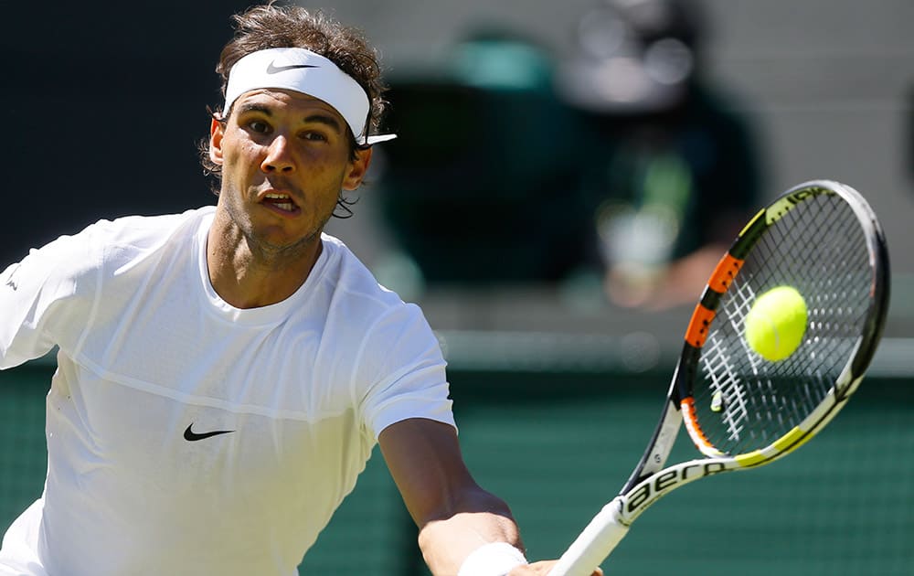 Rafael Nadal of Spain plays a return to Thomaz Bellucci of Brazil during the singles first round match at the All England Lawn Tennis Championships in Wimbledon, London.