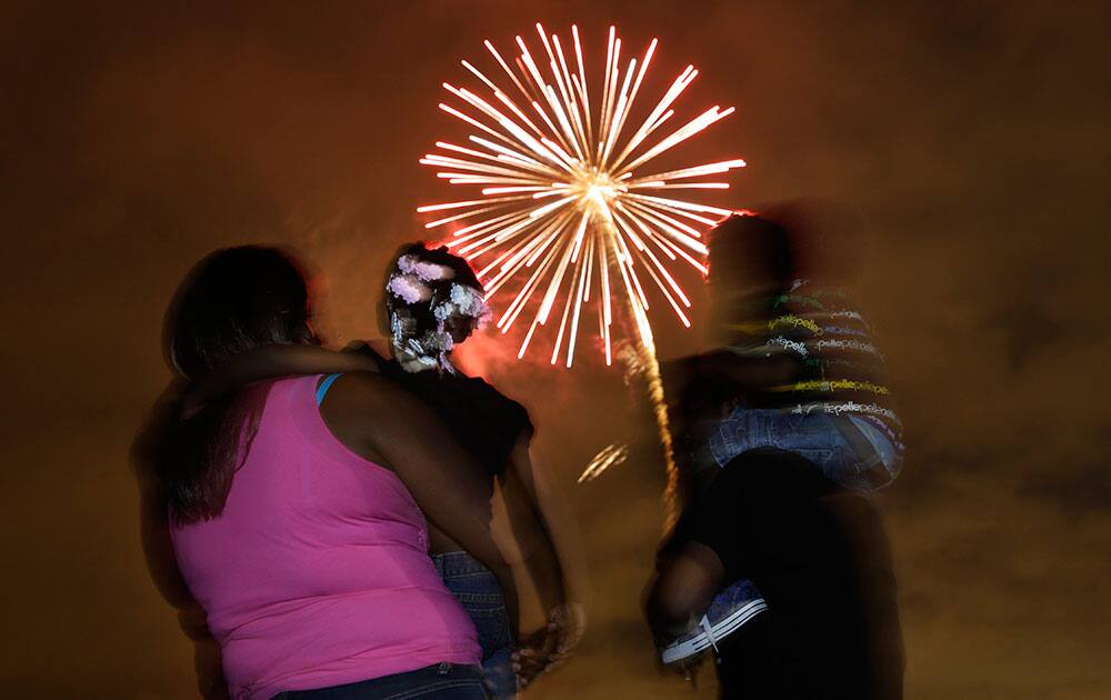 People watch a fireworks display in Newark, N.J.