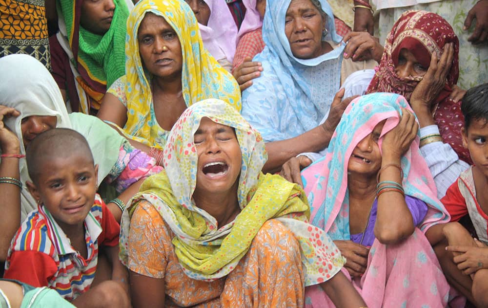 Relatives wail after a youth was shot dead in a clash between two groups in Muzaffarnagar.