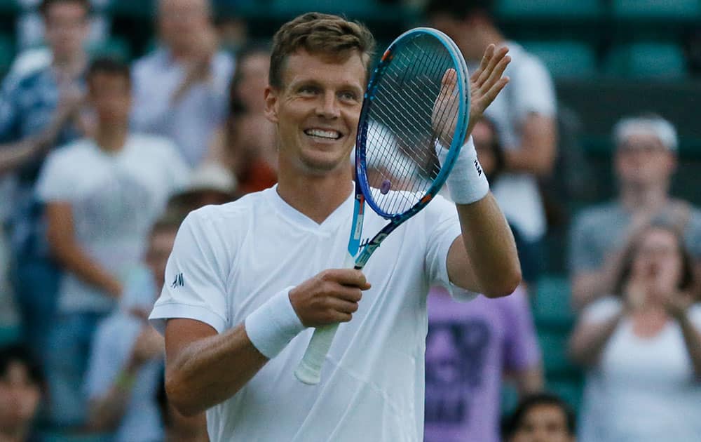 Tomas Berdych of the Czech Republic celebrates defeating Jeremy Chardy of France in the singles first round match at the All England Lawn Tennis Championships in Wimbledon, London.