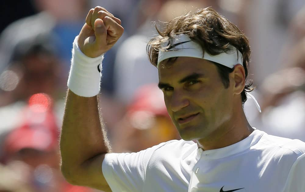 Roger Federer of Switzerland celebrates after defeating Damir Dzumhur of Bosnia in the singles first round match at the All England Lawn Tennis Championships in Wimbledon, London.