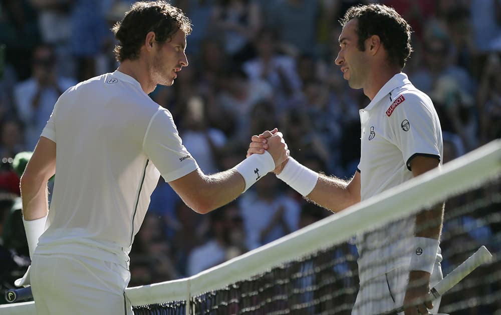 Andy Murray of Britain shakes hands after defeating Mikhail Kukushkin of Kazakhstan in their singles first round match at the All England Lawn Tennis Championships in Wimbledon, London. Murray won the match 6-4, 7-6, 6-4.