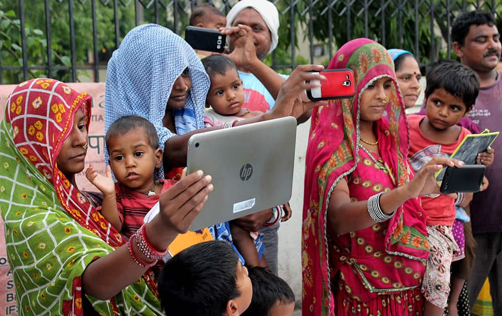 Women take selfies with their girl children as part of the Beti Bachao Beti Padhao campaign in Nagpur.