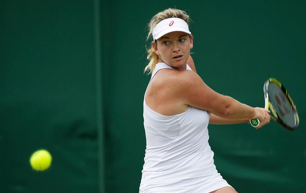 Coco Vandeweghe of the United States returns a shot to Karolina Pliskova of the Czech Republic during the women's singles match, at the All England Lawn Tennis Championships in Wimbledon, London.