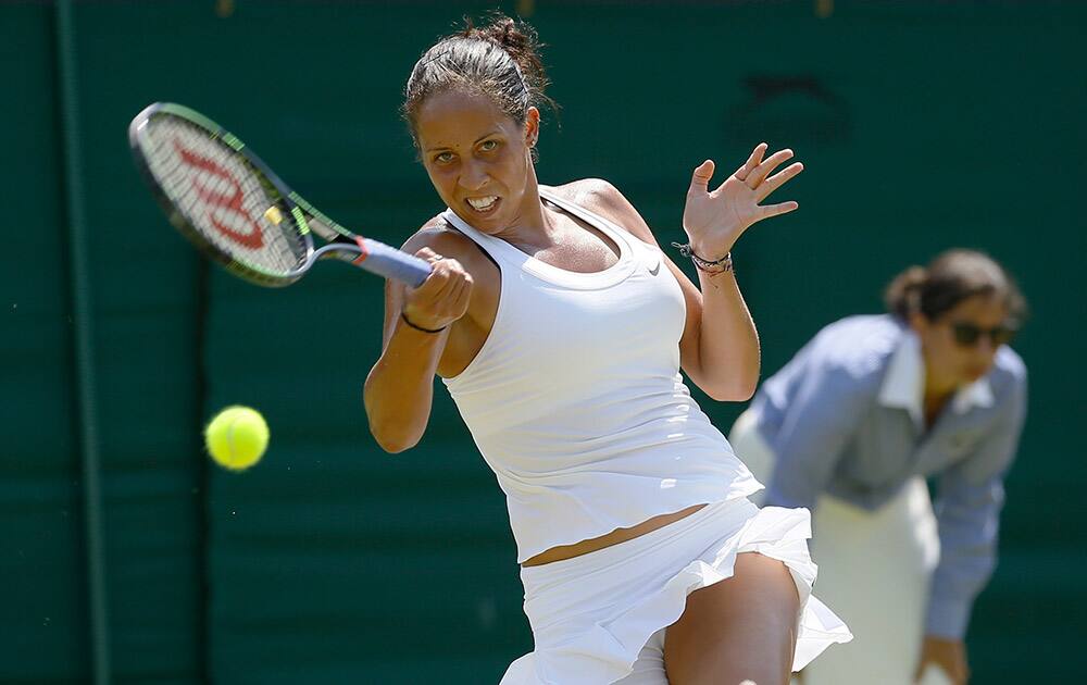 Madison Keys of the United States returns a shot to Stefanie Voegele of Switzerland during their singles match at the All England Lawn Tennis Championships in Wimbledon, London.