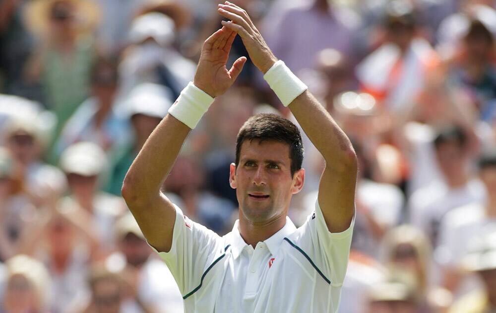 Novak Djokovic of Serbia celebrates after winning the singles match against Jarkko Nieminen of Finland, at the All England Lawn Tennis Championships in Wimbledon, London. Djokovic won 6-4, 6-2, 6-3. 