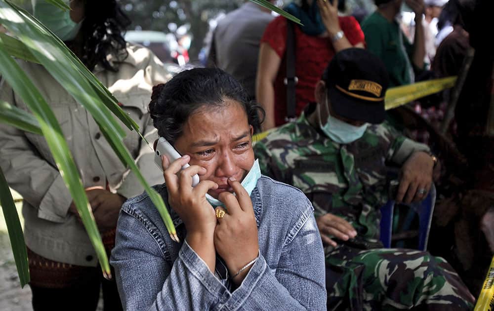 A relative weeps as she waits for the identification of the victims of a military cargo plane that crashed onto a residential area on Tuesday, at a hospital in Medan, North Sumatra, Indonesia.