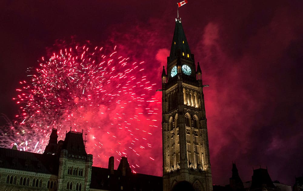 Fireworks explode behind the Peace Tower on Parliament Hill during Canada Day celebrations in Ottawa, Ontario.
