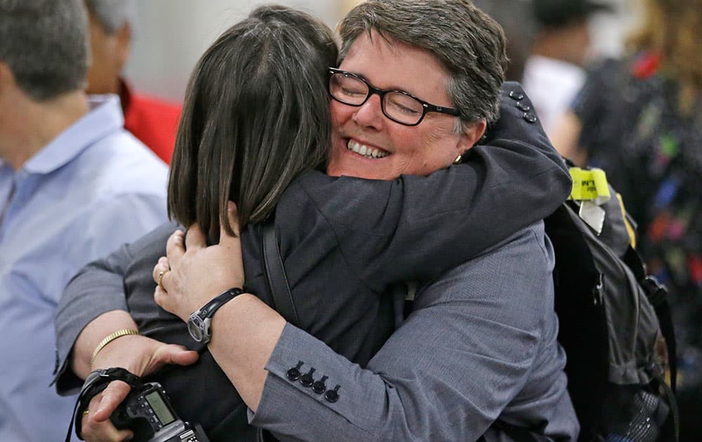 The Rev. Cynthia Black, right, and the Rev. Bonnie Perry, left, hug after Episcopalians voted to allow religious weddings for same-sex couples, in Salt Lake City. 