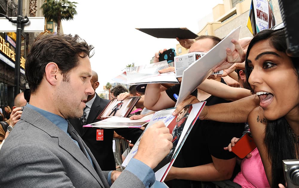 Actor Paul Rudd signs his autograph for fans at a ceremony honoring him with a star on the Hollywood Walk of Fame, in Los Angeles. 