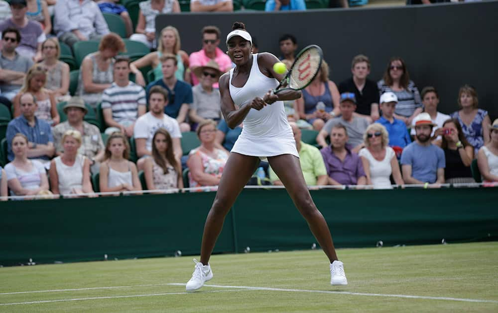 Venus Williams of the United States returns a shot to Yulia Putintseva of Kazakhstan during their singles match at the All England Lawn Tennis Championships in Wimbledon, London.