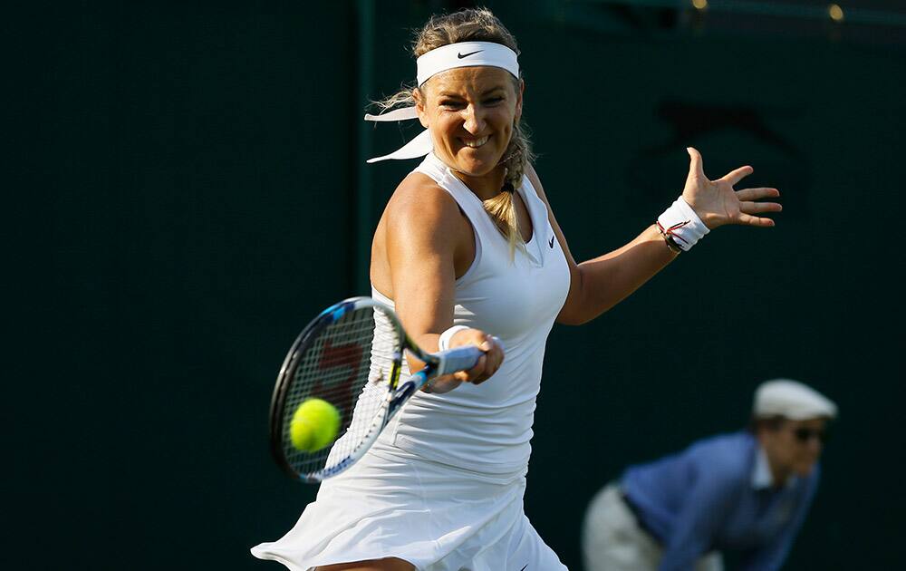 Victoria Azarenka of Belarus makes a return to Kirsten Flipkens of Belgium during their singles match at the All England Lawn Tennis Championships in Wimbledon, London.