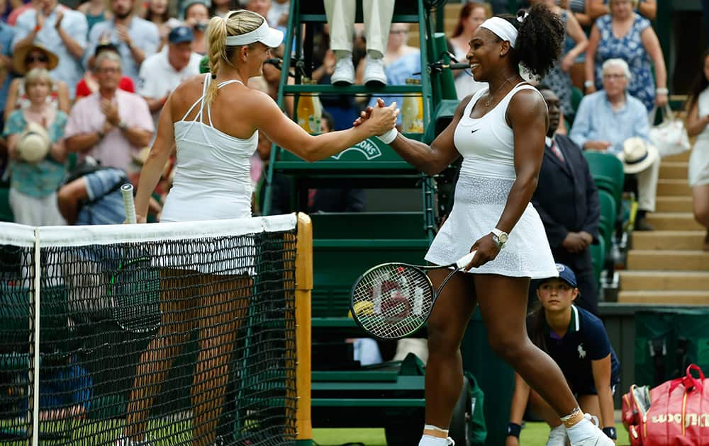 Serena Williams of the United States shakes hands with Timea Babos of Hungary, after defeating her, during their singles match at the All England Lawn Tennis Championships in Wimbledon, London.