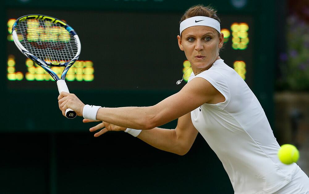 Lucie Safarova of the Czech Republic returns a shot to Su-Wei Hsieh of Taiwan during their singles match at the All England Lawn Tennis Championships in Wimbledon, London.